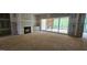 Open living room with fireplace, large sliding glass doors, and lots of natural light at 7934 Wexford Waters Ln, Wake Forest, NC 27587