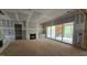 Open living room with fireplace, large sliding glass doors, and lots of natural light at 7934 Wexford Waters Ln, Wake Forest, NC 27587