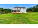 Expansive backyard view of a home showcasing a wooden deck, screened porch, and lush greenery at 90 Demascus Way # 024, Four Oaks, NC 27524