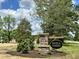 Elegant stone community sign reading 'Berea Farms' amidst landscaped grounds and lush trees at 90 Demascus Way # 024, Four Oaks, NC 27524