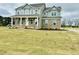 Inviting two-story home with classic architectural details and a spacious front yard at 90 Demascus Way # 024, Four Oaks, NC 27524