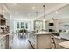 Modern kitchen with island that opens to the dining room and living room with fireplace at 90 Demascus Way # 024, Four Oaks, NC 27524