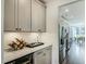Contemporary kitchen with stylish gray cabinets, stainless steel refrigerator, and dining area in background at 90 Demascus Way # 024, Four Oaks, NC 27524