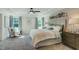 Inviting main bedroom with tray ceilings, soft decor, and abundant natural light from large windows at 90 Demascus Way # 024, Four Oaks, NC 27524