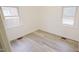 Well-lit bedroom with wood-look floors and two windows at 915 Da Vinci St, Durham, NC 27704