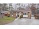 Brick ranch house with a front yard, driveway, and wooden fence at 915 Da Vinci St, Durham, NC 27704