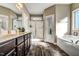 Elegant bathroom with soaking tub, double vanity, and walk-in shower at 10080 Nc-39, Middlesex, NC 27557