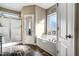 Bathroom with soaking tub, glass shower, and updated flooring at 10080 Nc-39, Middlesex, NC 27557