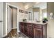 Double vanity bathroom with dark wood cabinets and a large mirror at 10080 Nc-39, Middlesex, NC 27557