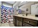 Clean bathroom with dark wood cabinets and geometric shower curtain at 10080 Nc-39, Middlesex, NC 27557