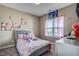 Charming bedroom with floral bedding and plenty of natural light at 10080 Nc-39, Middlesex, NC 27557