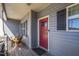 Front porch with red door and wooden rocking chairs at 10080 Nc-39, Middlesex, NC 27557