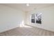 Spacious bedroom with large window and carpet at 105 Danesway Dr, Holly Springs, NC 27540