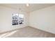 Bright bedroom with window and carpet flooring at 105 Danesway Dr, Holly Springs, NC 27540
