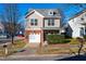 Two-story townhome with brick accents and attached garage at 105 Danesway Dr, Holly Springs, NC 27540