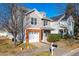 Two-story townhome with brick accents and attached garage at 105 Danesway Dr, Holly Springs, NC 27540