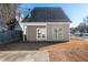 Tan house exterior with a small covered patio at 105 Danesway Dr, Holly Springs, NC 27540