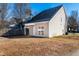 Tan house exterior with a small covered patio at 105 Danesway Dr, Holly Springs, NC 27540