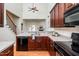 Modern kitchen with dark wood cabinets and black appliances at 105 Danesway Dr, Holly Springs, NC 27540