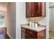 Dark wood cabinets and neutral countertop kitchen at 105 Danesway Dr, Holly Springs, NC 27540