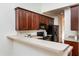 Modern kitchen with dark wood cabinets and black appliances at 105 Danesway Dr, Holly Springs, NC 27540