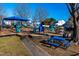 Community playground with play structures and picnic table at 105 Danesway Dr, Holly Springs, NC 27540