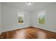 Bright bedroom with hardwood floors and white walls, featuring two windows for natural light at 1108 Taylor St, Durham, NC 27701