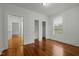 Bedroom featuring hardwood floors, white walls, closet and natural light at 1108 Taylor St, Durham, NC 27701