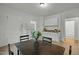 Dining room with table and chairs, white cabinets, and adjacent rooms visible at 1108 Taylor St, Durham, NC 27701