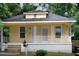 Lovely bungalow with a welcoming front porch, decorative white railing, and easy access stairs at 1108 Taylor St, Durham, NC 27701