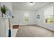 Bright living room with a fireplace, neutral carpet, white walls, and natural light from the windows at 1108 Taylor St, Durham, NC 27701