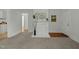 Charming living room with a decorative fireplace, plush carpet, and white wood paneled walls at 1108 Taylor St, Durham, NC 27701