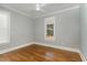 Bright bedroom with hardwood floors and a window at 113 Meadowglades Ln, Cary, NC 27518