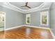 Bright bedroom with hardwood floors and ceiling fan at 113 Meadowglades Ln, Cary, NC 27518