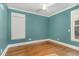 Charming bedroom with hardwood floors and two windows at 113 Meadowglades Ln, Cary, NC 27518