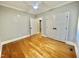 Well-lit bedroom featuring hardwood floors and double doors at 113 Meadowglades Ln, Cary, NC 27518