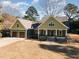 Craftsman style home with green siding, two-car garage, and stone accents at 113 Meadowglades Ln, Cary, NC 27518