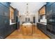 Spacious kitchen with dark cabinetry, granite island, and stainless steel appliances at 113 Meadowglades Ln, Cary, NC 27518