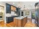 Eat-in kitchen with island, stainless steel appliances, and French doors at 113 Meadowglades Ln, Cary, NC 27518