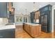 Modern kitchen with two-toned cabinetry, granite countertops, and large island at 113 Meadowglades Ln, Cary, NC 27518