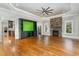 Bright living room with hardwood floors, fireplace, and built-in entertainment center at 113 Meadowglades Ln, Cary, NC 27518