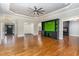 Spacious living room featuring hardwood floors, a fireplace, and built-in shelving at 113 Meadowglades Ln, Cary, NC 27518