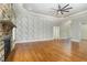 Living room with hardwood floors, stone fireplace, and accent wall at 113 Meadowglades Ln, Cary, NC 27518