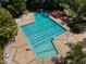 Aerial view of a community pool with lap lanes, a waterslide, sundeck, and many chairs with umbrellas at 113 Meadowglades Ln, Cary, NC 27518