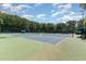 Well-maintained community tennis courts surrounded by lush greenery and shaded benches at 113 Meadowglades Ln, Cary, NC 27518