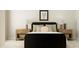 Serene bedroom with a black bed frame and wooden nightstands at 1528 Goldfinch Perch Ln, Knightdale, NC 27545