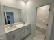 Bright bathroom features modern fixtures, double sinks, and a large mirror at 1528 Goldfinch Perch Ln, Knightdale, NC 27545