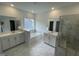 Bright bathroom features marble floors, double sinks, and a luxurious tub and glass shower at 1528 Goldfinch Perch Ln, Knightdale, NC 27545