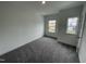 Bedroom has neutral walls, carpeted floors, with a window and closet space at 1528 Goldfinch Perch Ln, Knightdale, NC 27545