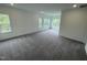 Spacious room with neutral walls and carpeting with natural light from multiple windows at 1528 Goldfinch Perch Ln, Knightdale, NC 27545